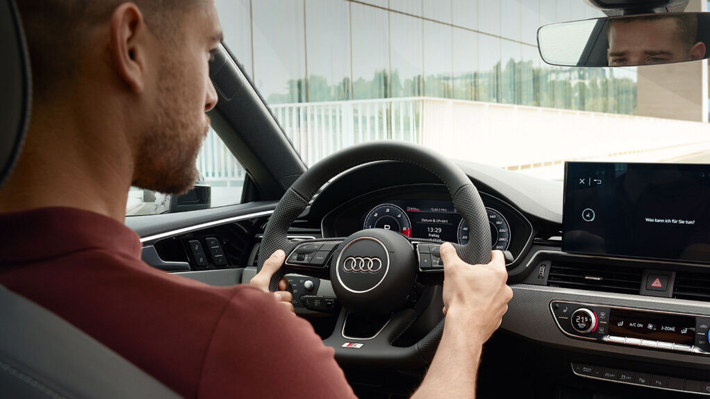 Audi A5 Fahrer bedient Infotainmentsystem 