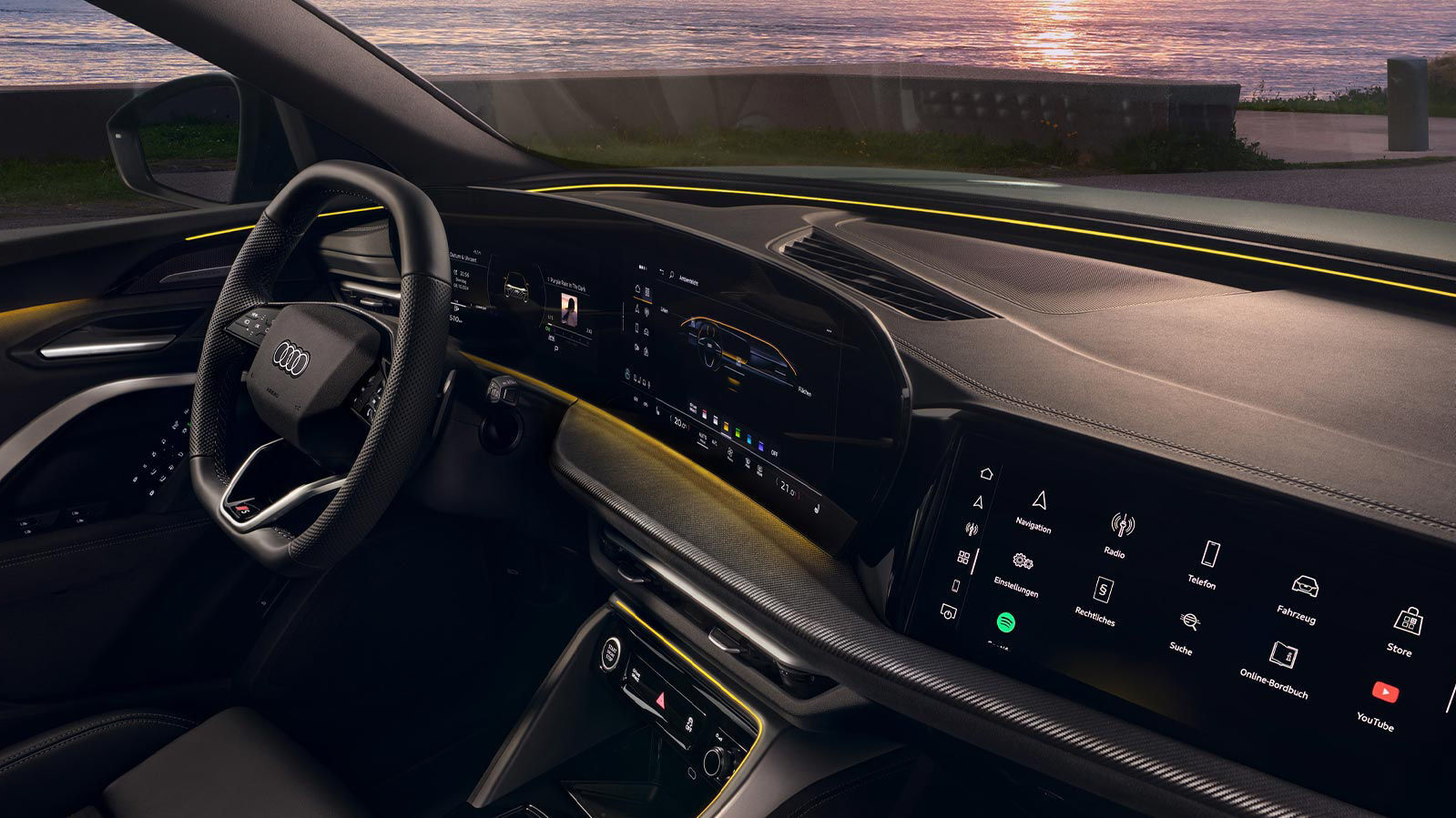 Cockpitansicht des Audi Q5 Sportback mit Audi Virtual Cockpit plus, großem MMI-Touchdisplay, Ambientebeleuchtung, 3 zonen komfortklimaautomatik und Lederlenkrad mit perforiertem Griffbereich.