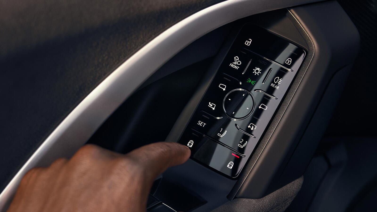 Detailansicht des Soft-Touch-Bedienfeldes im Audi Q5 Sportback – eine Hand bedient die kapazitive Steuerung, Einstellungen und Tasten für Licht, Spiegel, Memory-Sitzfunktion und Türverriegelung.
